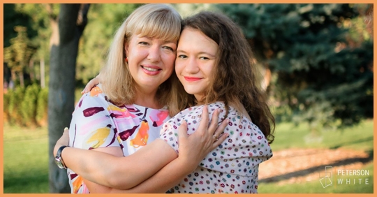 Mother and teenage daughter embracing